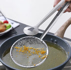 Fine mesh oil strainer tongs removing food particles from frying oil