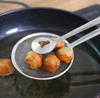 Stainless steel mesh strainer tongs holding fried food above cooking oil