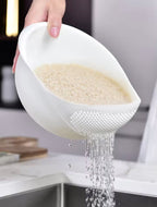 Rice rinsing bowl draining cloudy water through built-in colander