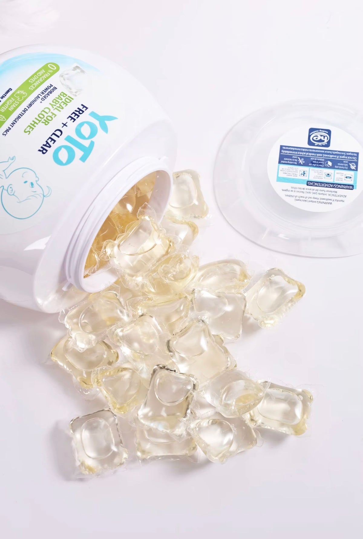 YOTO Free + Clear unscented laundry detergent capsules spilling from container